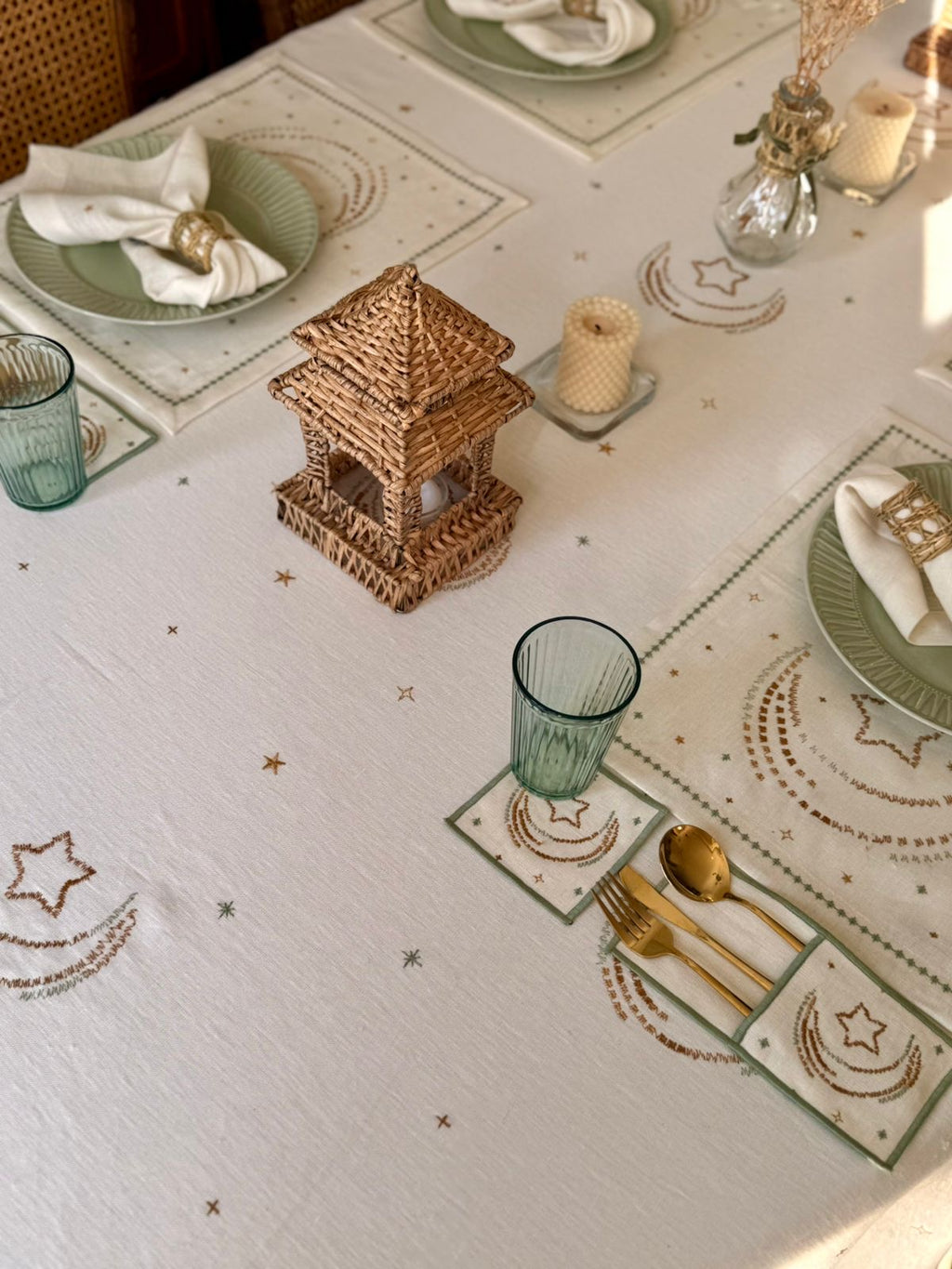 Decorative table setting with star and moon patterns on a white tablecloth.
Woven decorative lantern on a bathroom counter with a candle and towel.
ramadan decoration زينة رمضان للبيت
مفرش رمضان - فوط رمضان