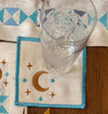 Decorative table setting with gold cutlery, plates, and a patterned placemat.