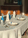 ramadan Dining table set with blue and white decor, including plates, glasses, and cutlery.